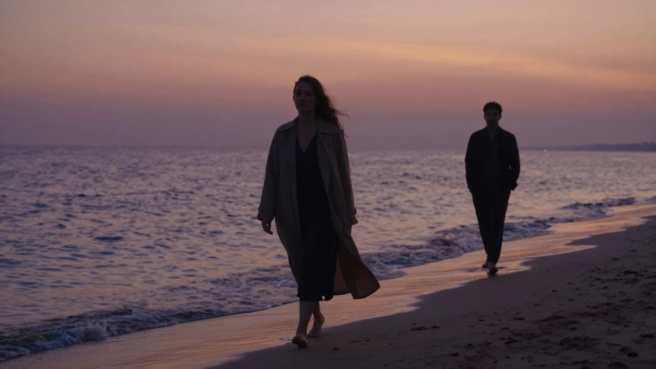 A silhouette of a woman walking along a beach at sunset, with a distant figure behind her in quiet companionship.